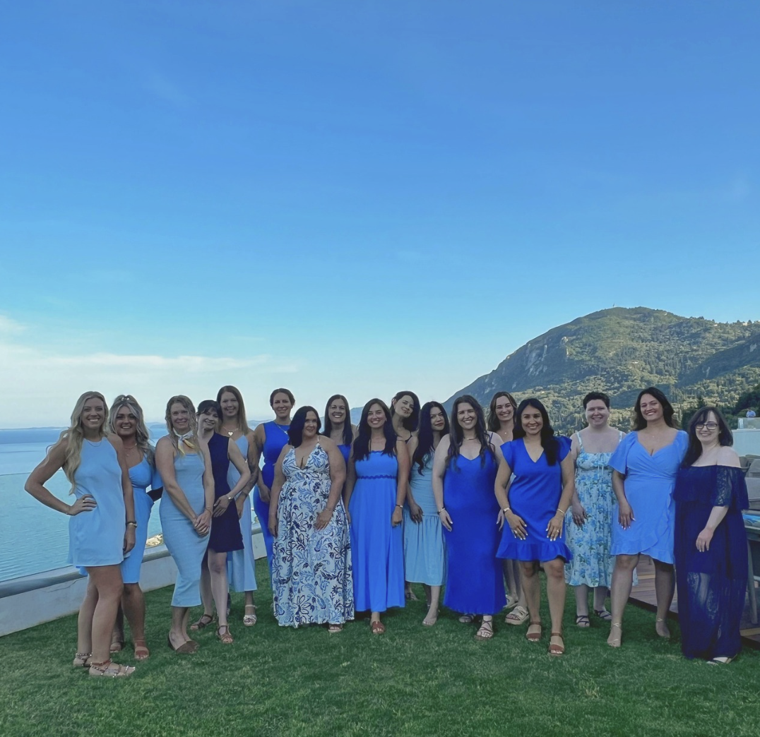 SERA travelers in blue dresses overlooking the coast in Corfu