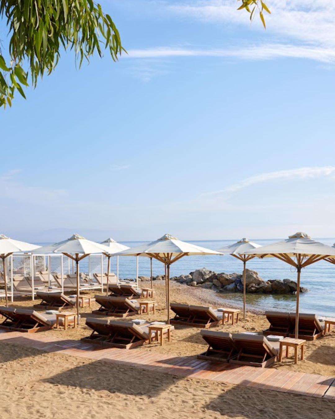 Beach cabanas and umbrellas on turquoise water